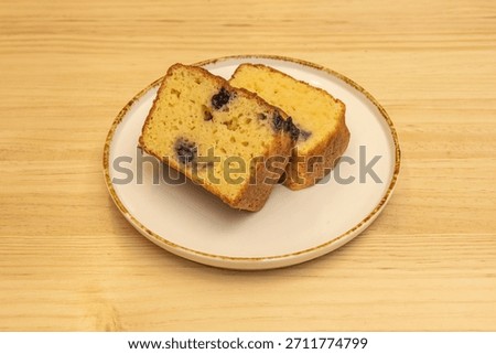 A selection of assorted cakes including classic yogurt cake, lemon cake with glaze, and chocolate chip cake, presented in slices on a rustic wooden board