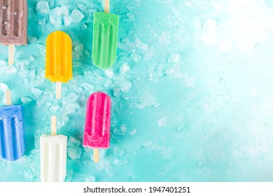 Selection of bright multicolored ice cream popsicle. Various gelato, frozen lollypops - chocolate vanilla blueberry strawberry pistachio orange, with crushed ice on light blue sunny background