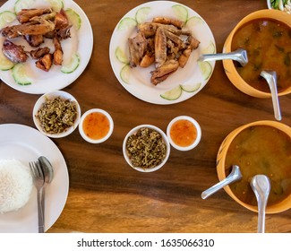 Selection Of Burmese Dishes In Rural Myanmar With Skinny Chicken And Traditional Soup