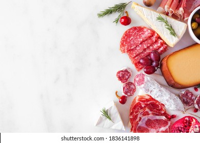 Selection Of Cheese And Meat Appetizers. Above View Side Border On A White Marble Background With Copy Space.