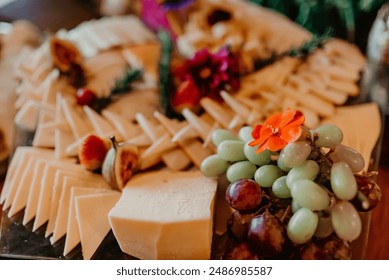 A selection of cheese and snacks displayed on a wooden table, providing a colorful and inviting spread for guests