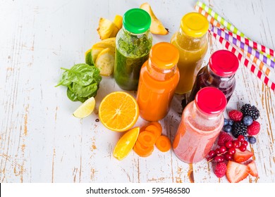 Selection of colourful smoothies on rustic wood background, copy space