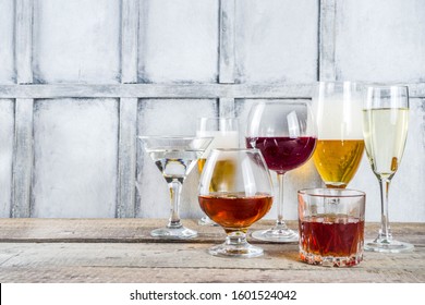 Selection of different alcoholic drinks - beer, red white wine, martini, champagne, cognac, whiskey in various glasses