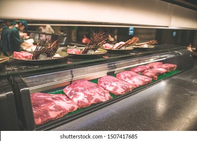 Selection Of Different Cuts Of Fresh Beef Meat On Display In A Butchery In A Refrigerated Counter.