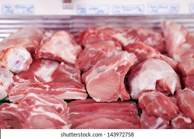 Selection Of Different Cuts Of Fresh Meat On Display In A Butchery In A Refrigerated Counter