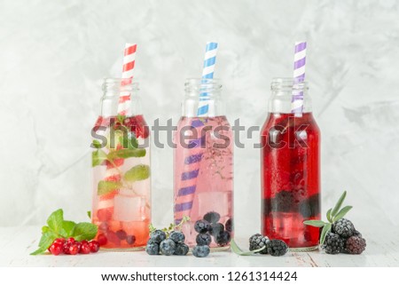 Similar – Infused water in bottles with drink straw and ingredients on white background, front view. Water Flavored with fruits, berries and herbs. Summer drinks. Healthy and clean detox beverages.