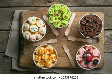 Selection of different rolled ice creams in cone cups