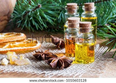 selection of essential oils with christmas spices and ingredients bottles of essential oil pine - Christmas Essential Oils selection of essential oils with christmas spices and ingredients bottles of essential oil pine - Christmas Essential Oils
