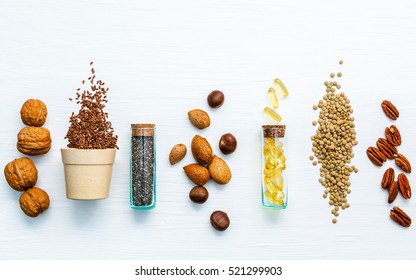 Selection food sources of omega 3 . Super food high omega 3 and unsaturated fats for healthy food. Almond ,pecan ,hazelnuts,walnuts ,fish ,flax seeds ,chia and lentils on white wooden background.