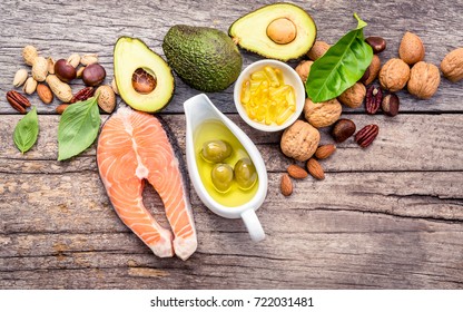 Selection food sources of omega 3 and unsaturated fats. Superfood high vitamin e and dietary fiber for healthy food. Almond,pecan,hazelnuts,walnuts,olive oil,fish oil and salmon on wooden background.