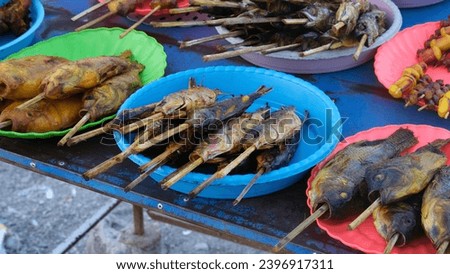 A selection of freshly cooked BBQ fish at street food cart seafood market in capital city of Dili, Timor-Leste in Southeast Asia 