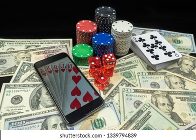 Selection Of Gambling Items, Poker Chips, Dice, Playing Cards And Money, With A Mobile Phone, Online Gambling