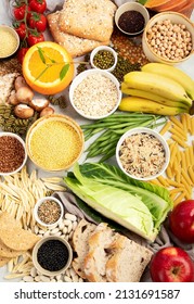 Selection Of Good Carbohydrates Sources - Vegetables, Fruits, Grains, Legumes, Nuts And Seeds On White Background, Top View.