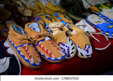 Selection of handmade beaded leather Native American Indian moccasins on display for sale at a powwow in San Francisco