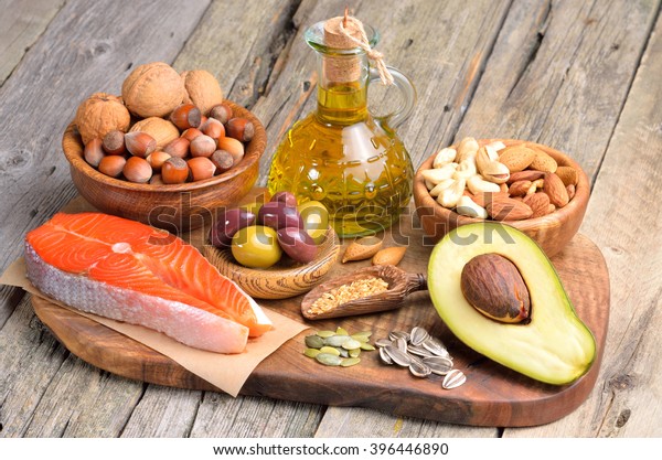 Selection of\
healthy fat sources on wooden\
background.