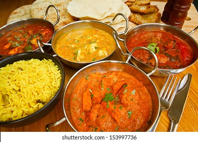 Selection of indian food with pilau rice, naan bread, poppadoms and samosas a popular choice for eating out in european countries