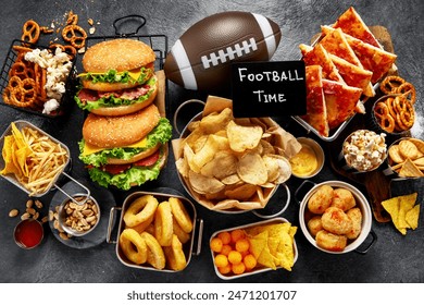 Selection of party food for watching football championship on a dark background, top view. Super Bowl.