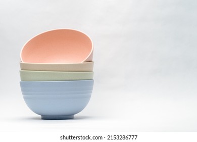 selection of pastel colored dining ware bowls stacked plain background - Powered by Shutterstock