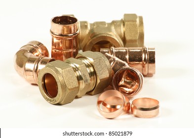 selection of plumbers pipe fittings isolated on a white background