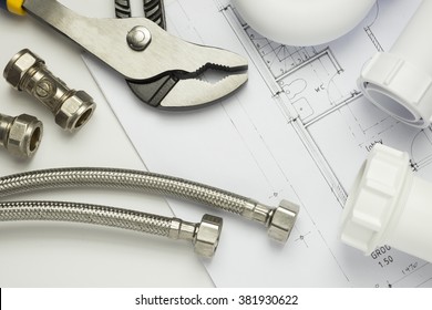 A selection of plumbing tools and fittings on house plans