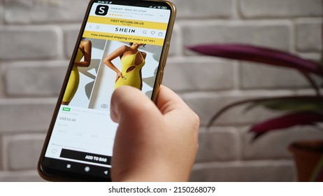 A Selection Of Products In The SHEIN Online Store. Buying Fashionable Clothes Right On Your Smartphone. A Woman's Hand With Her Phone Against A Light Stone Wall. Krasnodar, Russia, April 13, 2022