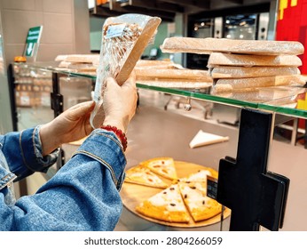 Selection of ready-made meals in the display case, including pizza and baguettes.