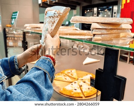 Selection of ready-made meals in the display case, including pizza and baguettes.