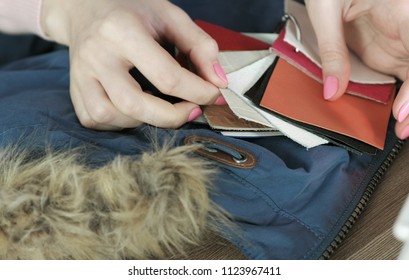 Selection of samples of leather fabric for sewing to the jacket. Women's hands with tissue samples.