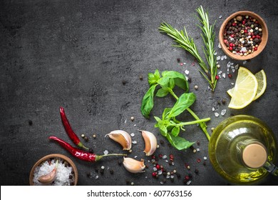 Selection Of Spices Herbs And Greens. Ingredients For Cooking. Food Background On Black Slate Table. Top View Copy Space.