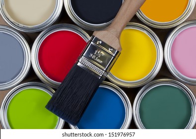 A Selection Of Tins Of Colorful Emulsion Paint.