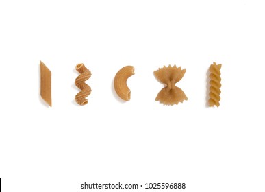 selection of whole grain pasta uncooked, isolated on white background