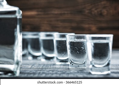  selectiv focus glasses of  cold vodka  on wooden table  - Shutterstock ID 366465125