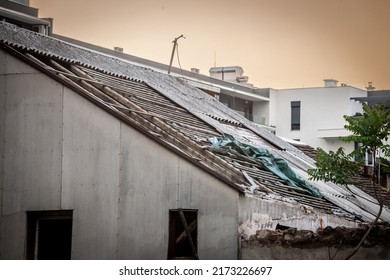 Selective Blur On An Abandoned Building, Damaged, With A Roof Made Of Asbestos Tiles, Toxic, Some Of The Roofing Having Been Removed To Protect People From The Asbestos Dangers.

