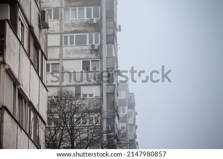 Selective blur on Communist housing buildings, decay, diplapidated, in Belgrade, Serbia, during a foggy mist smog. These are symbol of Socialist architecture  economic transition Eastern Europe faced