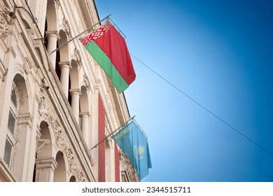 Selective blur on the flags of Belarus and Kazakhstan waiving together in the air in Belgrade streets. Belorussia and Kazakhstan are two former soviet states, part of CIS, Commonwealth of Independent 