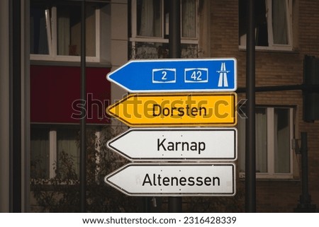 Selective blur on a german roadsign in Essen, Germany, indicating directions to the autobahn motorway and local smaller villages and cities: Dorsten, Karnap and Altenessen.
