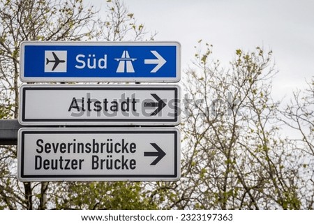 Selective blur on german roadsign in Cologne, Germany, directing to autobahn motorway heading south (Sud in German)  local road to Cologne districts of Severinsbrucke, Altstadt  Deutzer Brucke.