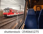 Selective blur on a German S-Bahn suburban train near Cologne seen from another train, part of Germany