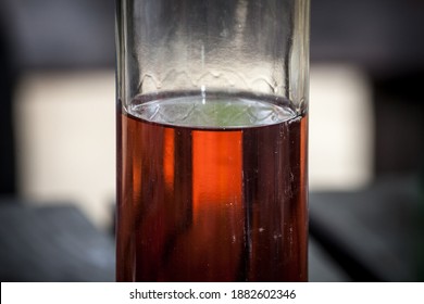 Selective Blur On An Half Empty Bottle Of Rose Wine Standing On A Vintage Wooden Rustic Table. Rose Is A Type Of Wine, Close To Red.

