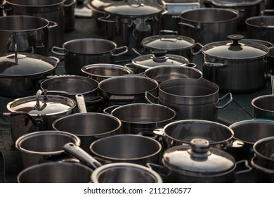 Selective blur on second hand kitchenware: metalware like pots and saucepans, pans, caldrons, in stainless steel and aluminum in the flea market of Obrenovacki Vasar. 