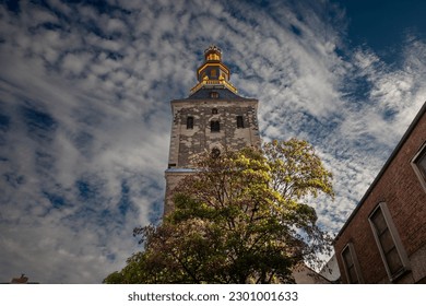 Selective blur on the steeple clocktower of the basilica of Saint Ursula in the afternoon. Sankt Ursula kirche is a Catholic church, a romanesque christian church of Cologne, Germany.