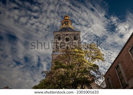Selective blur on the steeple clocktower of the basilica of Saint Ursula in the afternoon. Sankt Ursula kirche is a Catholic church, a romanesque christian church of Cologne, Germany.