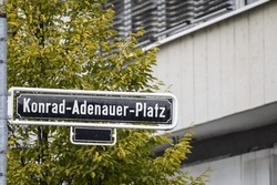 Selective Blur On A Street Sign Indicating Konrad Adenauer Platz Square, One Of The Main Squares Of Dusseldorf City Center Dedicated To Konrad Adenauer, Former Christian Democrat Chancellor Of Germany