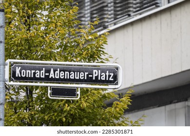 Selective blur on a street sign indicating Konrad Adenauer Platz square, one of the main squares of Dusseldorf city center dedicated to konrad adenauer, former christian democrat chancellor of germany