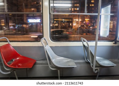 Selective blur on three empty plastic seats in an old vintage tram in belgrade, serbia, at night, with a speed blur in the background. Belgrade tram is one of public transportation systems of the city