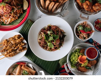 Selective Choice Food Table Shell Crab Noodle , Chicken Satay, Spring Roll, Curry Samosa, Fish Cake, Folks Drumlet, Pork Jar Salad In A Dish Isolated On Mat Top View On Grey Marble Background