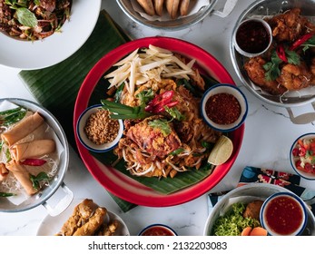 Selective Choice Food Table Shell Crab Noodle , Chicken Satay, Spring Roll, Curry Samosa, Fish Cake, Folks Drumlet, Pork Jar Salad In A Dish Isolated On Mat Top View On Grey Marble Background