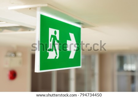 Selective fire exit sign on ceiling.Fire fighting equipment concept.