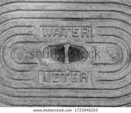 A selective focus abstract image of an old  rusty industrial water meter plate with metal texture background