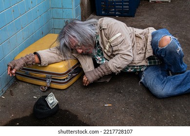 Selective Focus Addiction Aged Man Sitting On Dirty Street With Old Blanket Excited With Money Donation, Unemployed Homeless Get Cold Need Help For Medical Care, Abandoned Poverty Begging For Money.